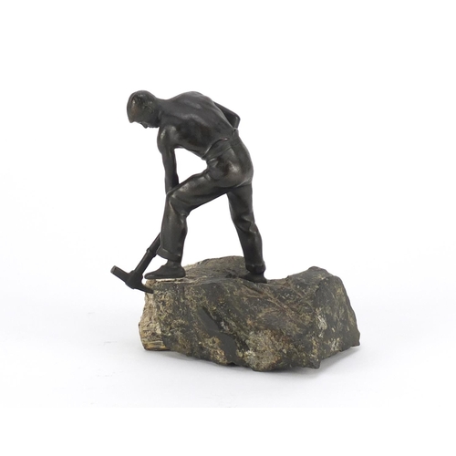 9 - Johann Robert Korn, patinated bronze of a young man with a pick axe, raised on a  naturalistic slate... 