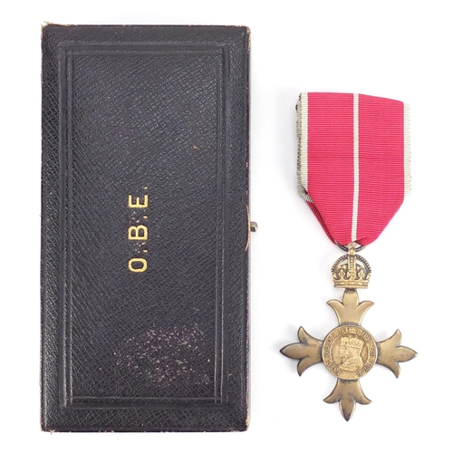 292 - Silver gilt OBE housed in a fitted silk and velvet lined leather case