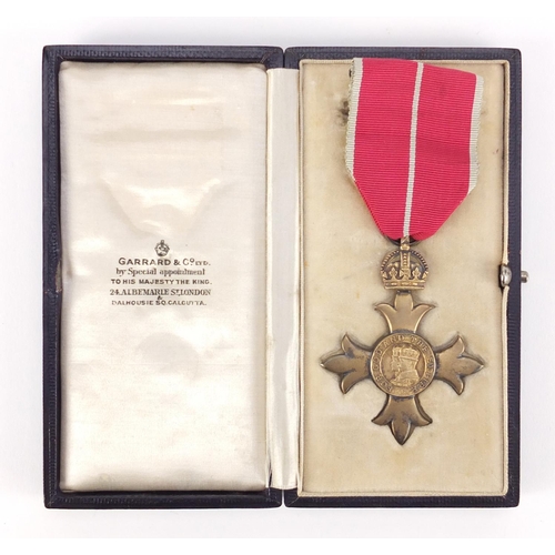 292 - Silver gilt OBE housed in a fitted silk and velvet lined leather case