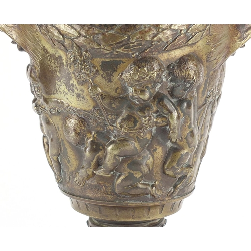 13 - 19th century classical patinated bronze urn and cover with rams head handles, cast in relief with fr... 