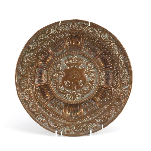 22 - Antique copper plate embossed with a heraldic crest, 27.5cm in diameter