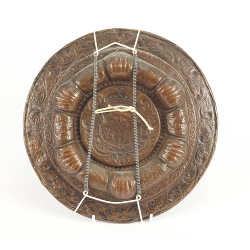22 - Antique copper plate embossed with a heraldic crest, 27.5cm in diameter