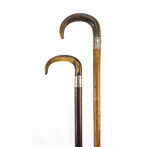 147 - Two horn handled walking sticks with silver collars, possibly rhinoceros horn, the largest 92cm in l... 