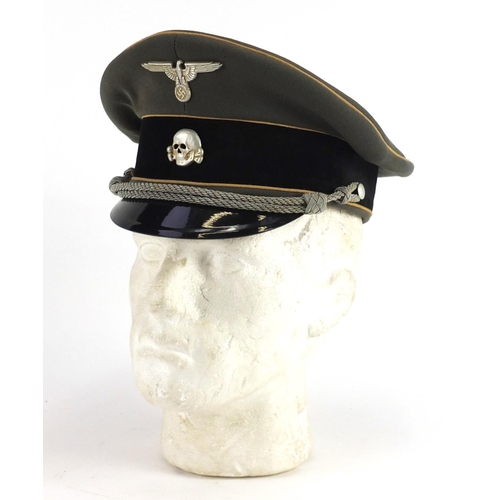312 - German Military interest visor cap with badges
