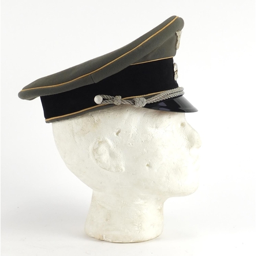 312 - German Military interest visor cap with badges