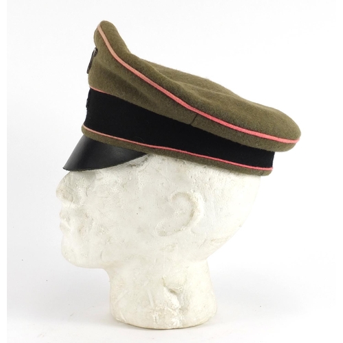 314 - German Military interest visor cap with badges