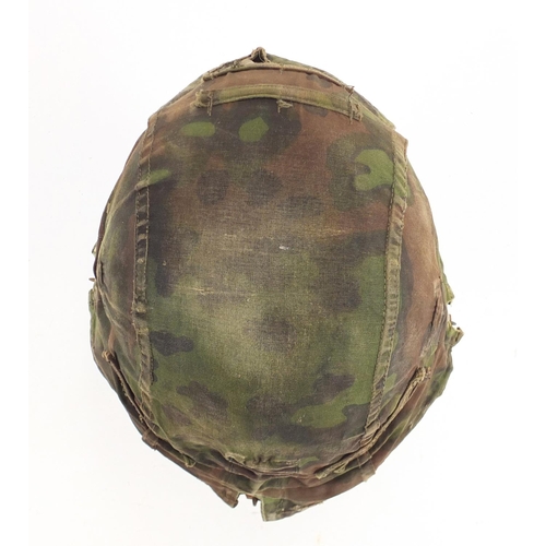 302 - German Military interest tin helmet with cover and leather liner, impressed marks to the interior