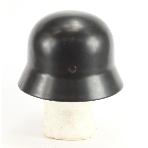 309 - German Military interest tin helmet with decal and leather liner, impressed marks to the interior