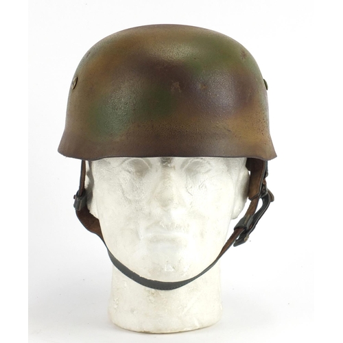 308 - German Military interest tin helmet with decal and leather liner, stamped marks to the interior