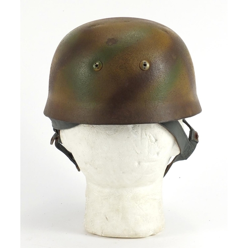 308 - German Military interest tin helmet with decal and leather liner, stamped marks to the interior