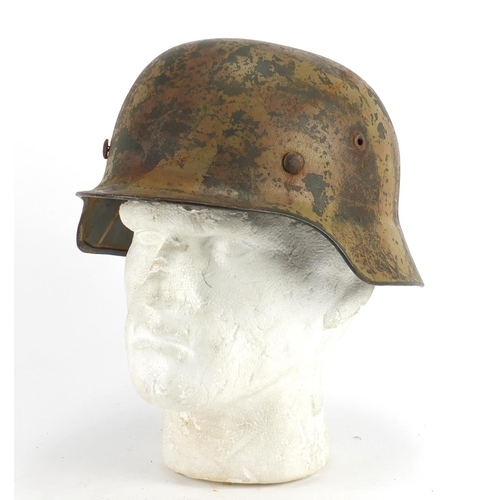 301 - German Military interest tin helmet with leather liner, impressed marks to the interior