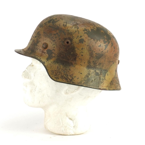 301 - German Military interest tin helmet with leather liner, impressed marks to the interior