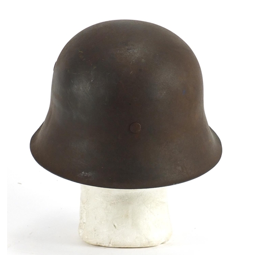 310 - German Military interest tin helmet with decals, impressed marks to the interior