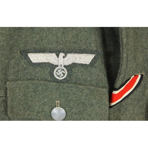 316 - German Military interest tunic with badges and epaulettes