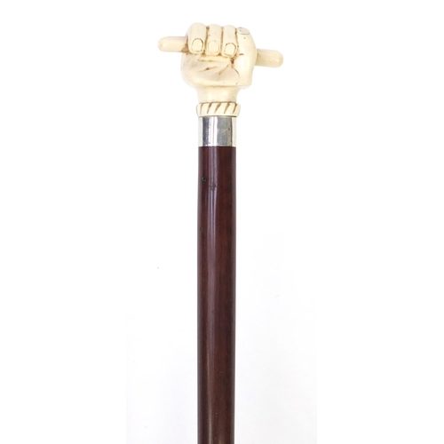 155 - Snakewood walking stick with carved ivory pommel in the form of a sailors clenched fist, 84cm in len... 