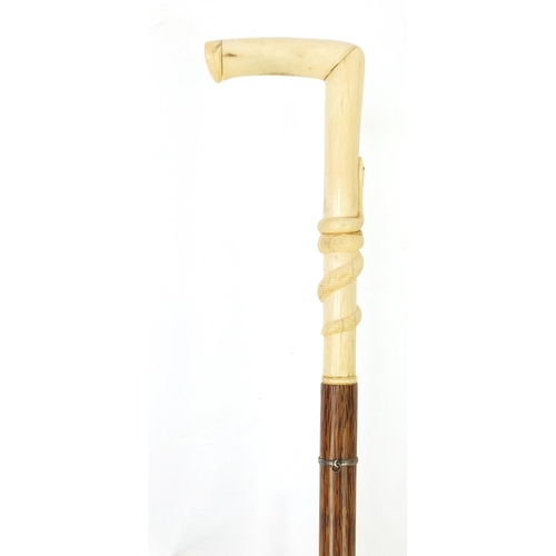 151 - Palmwood walking stick with bone handle carved with a serpent, possibly whale bone, 97cm in length