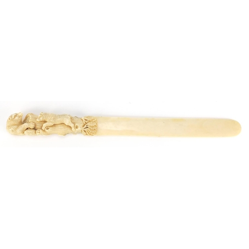 103 - Good 19th century ivory page turner, the handle finely carved with two bears climbing a trunk for ho... 