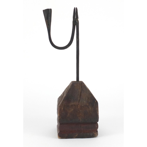 70 - 18th century steel rush light holder raised on a woodblock base, overall 32.5cm high