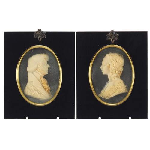 125 - Pair of Georgian style wax portrait miniatures by Leslie Ray, housed in ebonised frames, the miniatu... 