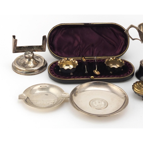 945 - Silver items including a three footed sauce boat, Chinese coin dish, pair of salts in a fitted case ... 