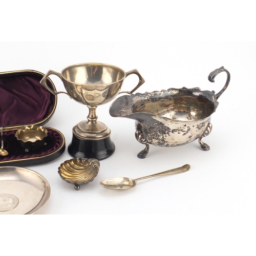 945 - Silver items including a three footed sauce boat, Chinese coin dish, pair of salts in a fitted case ... 