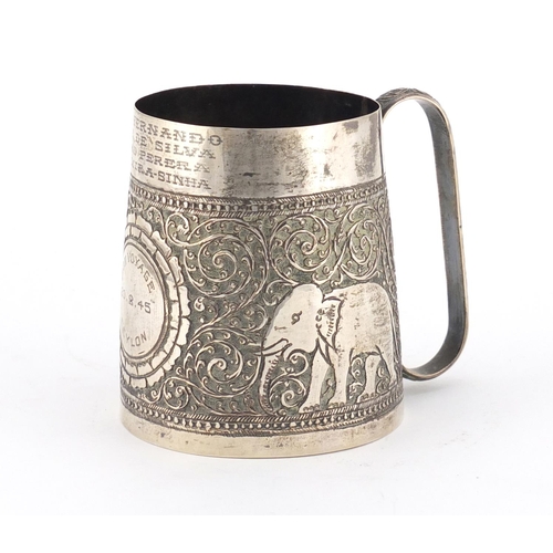 701 - Indian silver tankard profusely embossed with elephants amongst foliage, engraved Bon Voyage Ceylon ... 