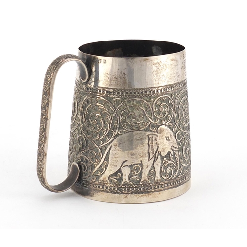 701 - Indian silver tankard profusely embossed with elephants amongst foliage, engraved Bon Voyage Ceylon ... 