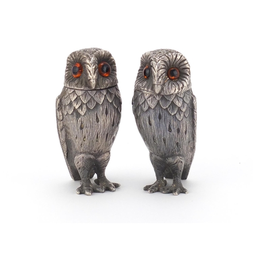 868 - Pair of novelty silver pepperette's in the form of owls by William Comyns, each with beaded glass ey... 