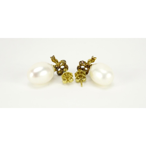 987 - Pair of cultured pearl and diamond bow design earrings, 2.5cm in length, 7.2g