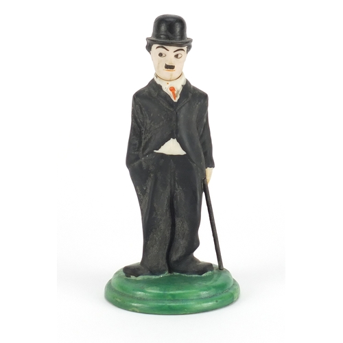 832 - Hand painted bisque figure of Charlie Chaplin with articulated head in the style of Hassell, registe... 