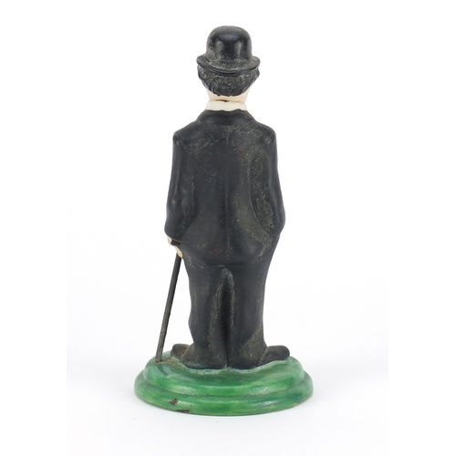 832 - Hand painted bisque figure of Charlie Chaplin with articulated head in the style of Hassell, registe... 
