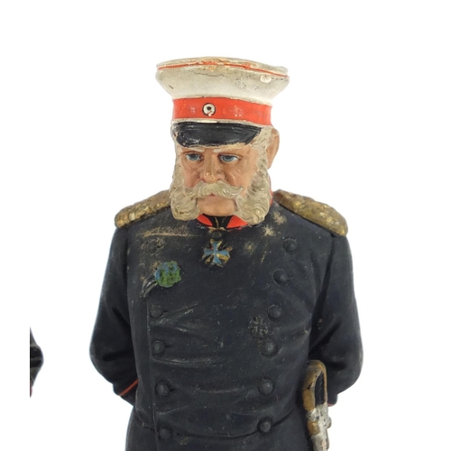 299 - Two German hand painted terracotta soldiers in Military dress by Deponirt, each 15cm high