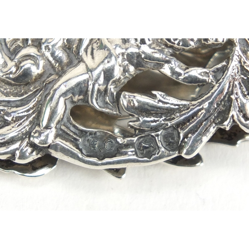870 - Victorian silver letter clip by William Comyns, pierced and embossed with a maiden and putti amongst... 