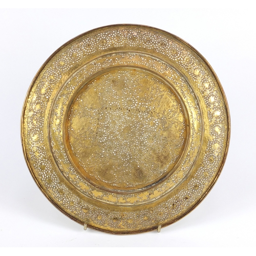 702 - Good Persian gilt copper dish, finely pierced and engraved with figures and flowers, 23cm in diamete... 