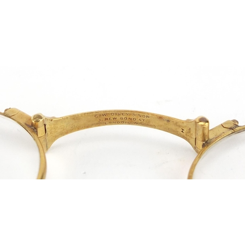 100 - Pair of unmarked gold folding lorgnette's by Dixey & Sons of London, 12cm in length when closed, 26.... 