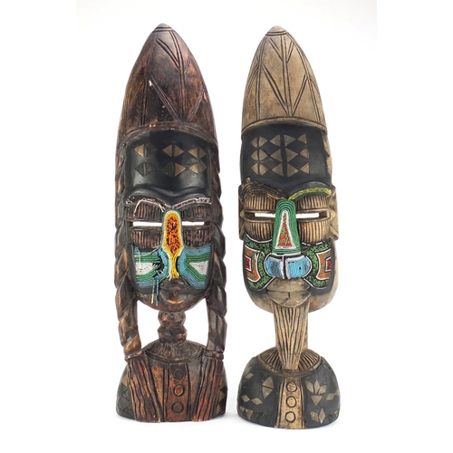 726 - Two tribal interest carved face masks with beadwork, the largest 63cm high