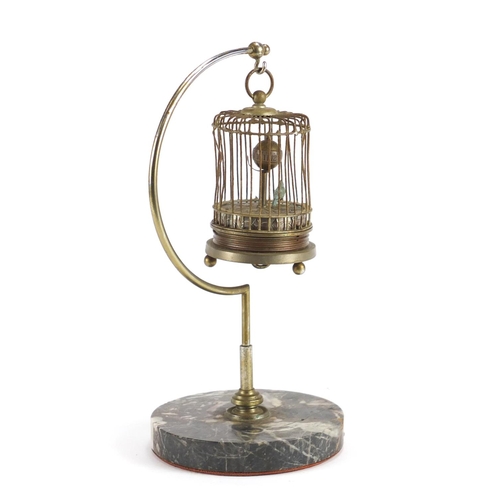 2186 - Clockwork automaton musical bird cage clock, raised on a hanging chrome and marble stand, 29cm high