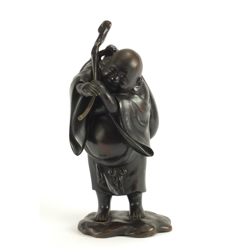 2354 - Japanese patinated bronze figure of a man holding a sack, character marks to the reverse, 30cm high