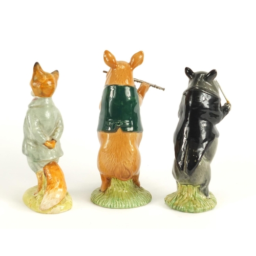 2492 - Two Beswick pig band figures and a Beatrix Potter figure, the largest 13cm high
