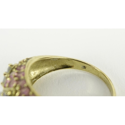 2799 - 9ct gold pink and purple stone flower head ring, size N, 3.2g