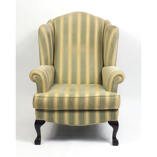 2085 - Mahogany framed wingback armchair with green and gold upholstery, raised on ball and claw feet, 108c... 