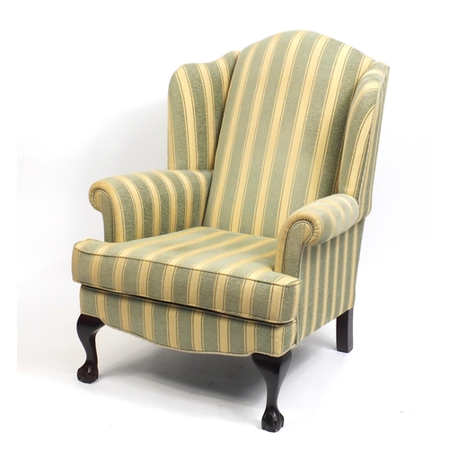 2084 - Mahogany framed wingback armchair with green and gold upholstery, raised on ball and claw feet, 108c... 