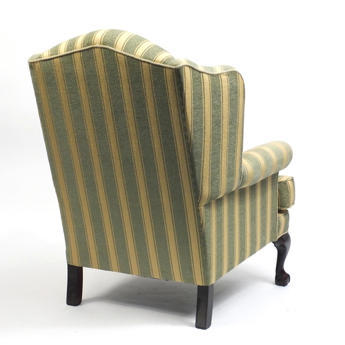 2084 - Mahogany framed wingback armchair with green and gold upholstery, raised on ball and claw feet, 108c... 