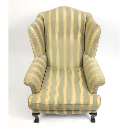 2083 - Mahogany framed wingback armchair with green and gold upholstery, raised on ball and claw feet, 108c... 