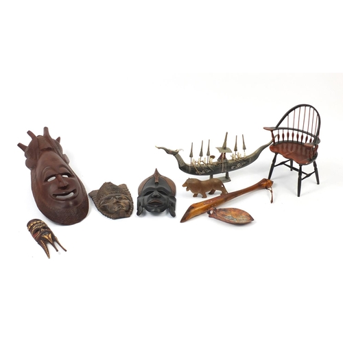 613 - African carved wood wall masks, a horn model boat and doll's chair