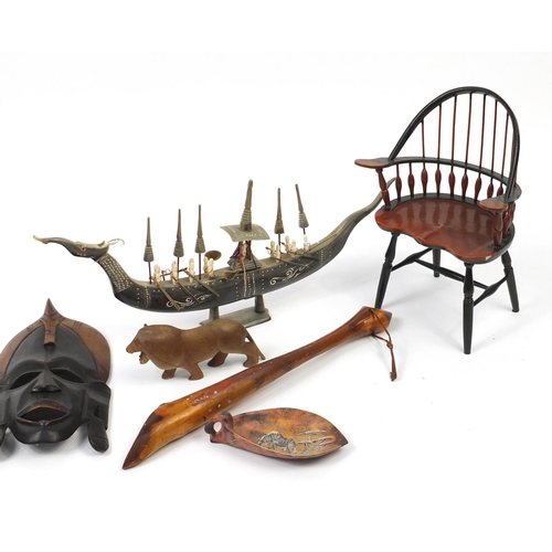 613 - African carved wood wall masks, a horn model boat and doll's chair