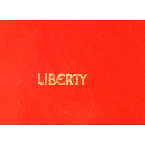 2372 - Octagonal red lacquered tray retailed by Liberty, 35cm in diameter