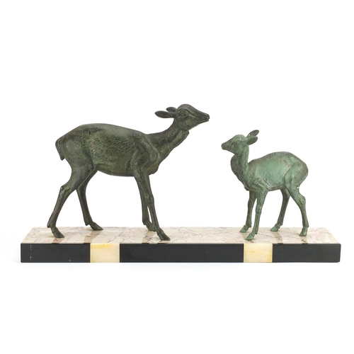 2127 - Art Deco bronzed sculpture of two deer raised on a marble base, 55.5cm wide
