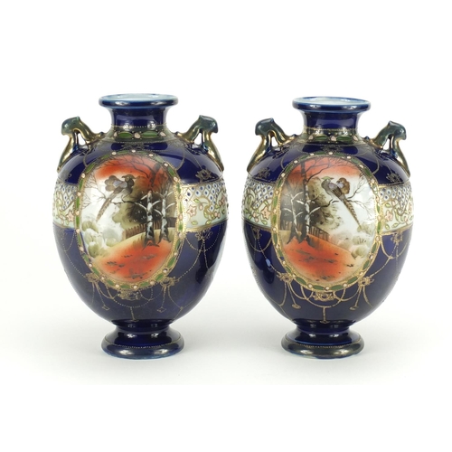 2251 - Pair of Japanese Kinjo vases with twin handles, hand painted with panels of landscapes, each 21cm hi... 