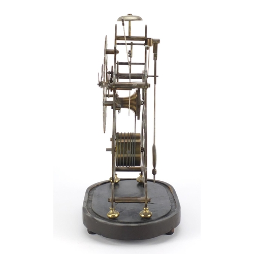 2174 - Gothic style brass  skeleton clock with fusee movement, under glass dome on an ebonised stand, overa... 